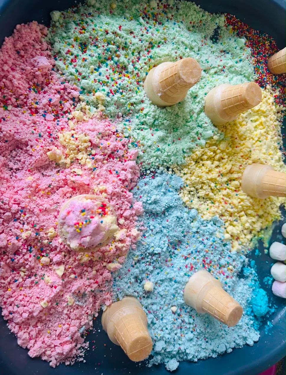 Rainbow messy play tray with ice cream cones and sprinkles